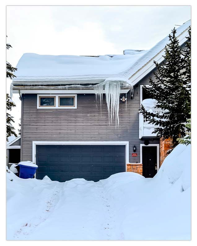 lots of snow in driveway in front of closed garage door