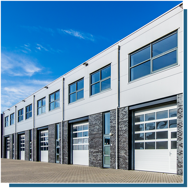 row of glass paneled garage doors on commercial building