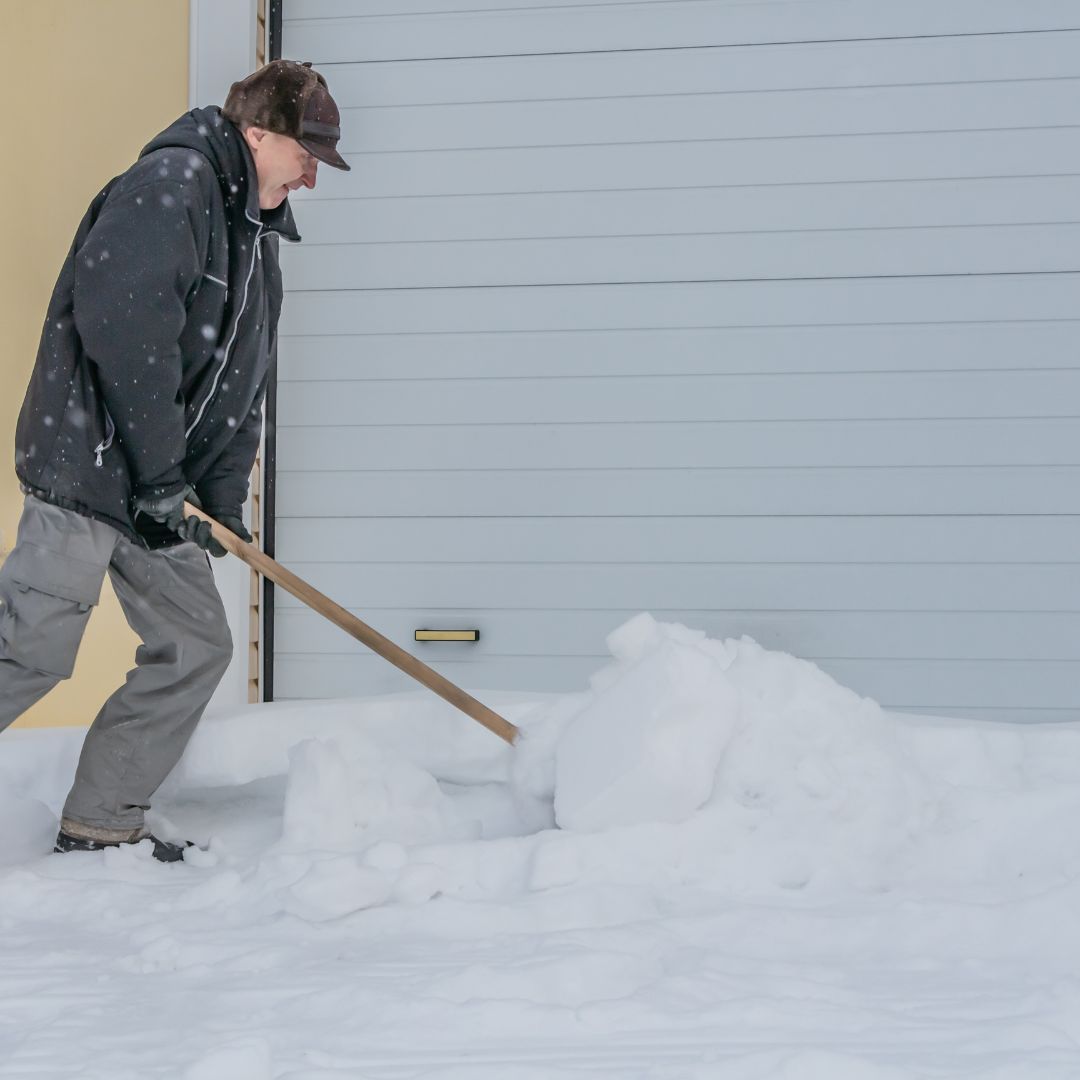 shoveling snow near garage door