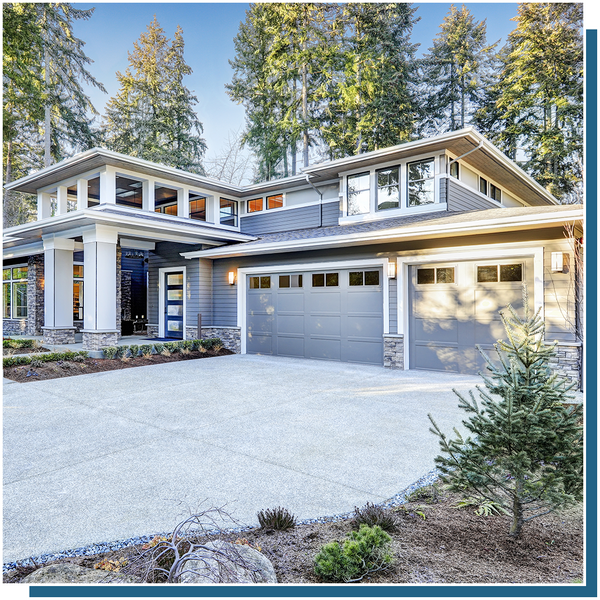 modern gray mountain home with panel garage doors