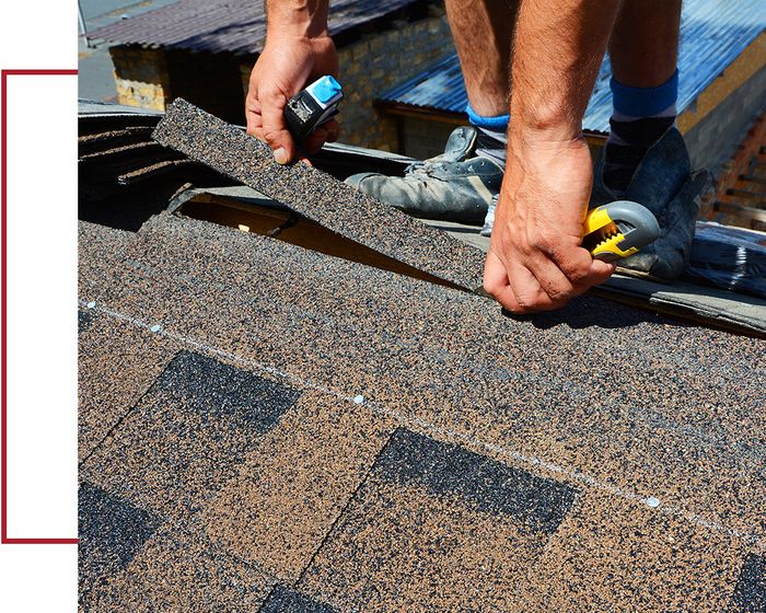 Roofer replacing damaged shingles