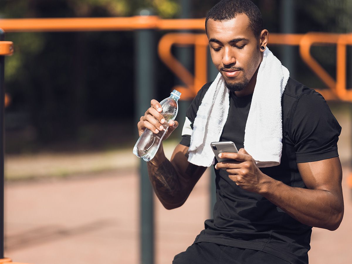 Image of a an athlete looking at his phone