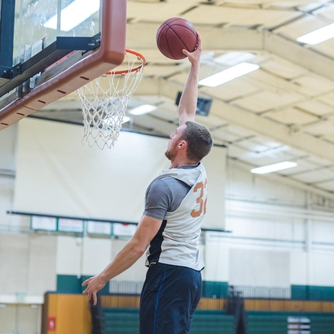 College recruit jumping to dunk the basketball