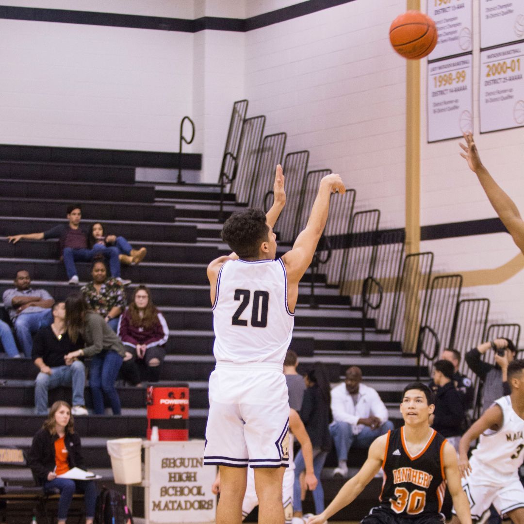 A college student playing basketball