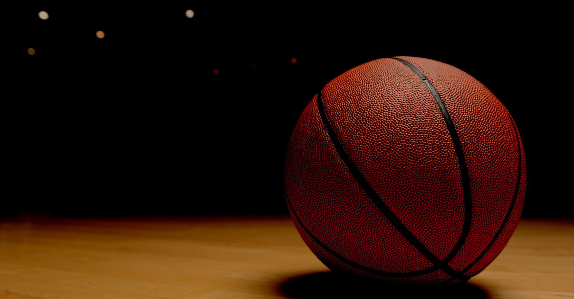 single basketball on a dark court