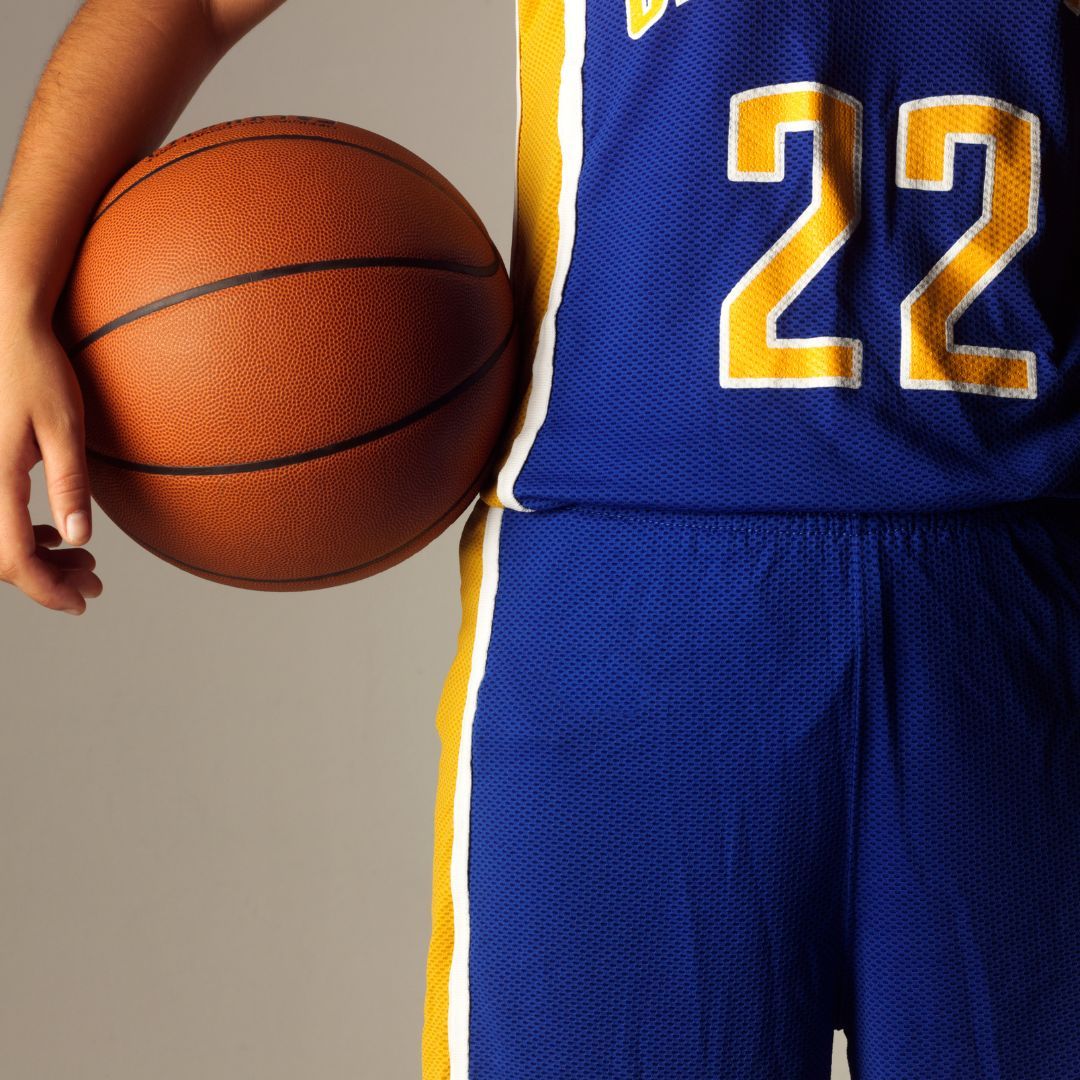 person holing a basketball while in uniform