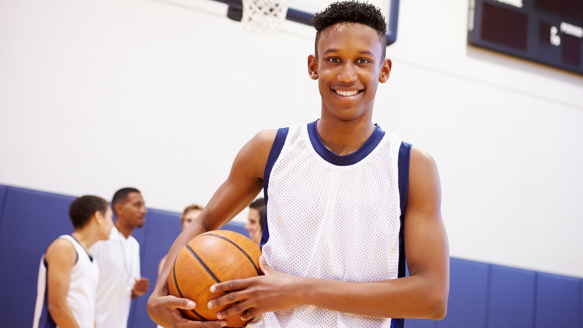 a high school basketball player holding a ball