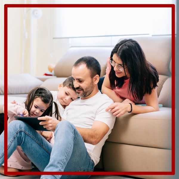 Family at home looking at tablet