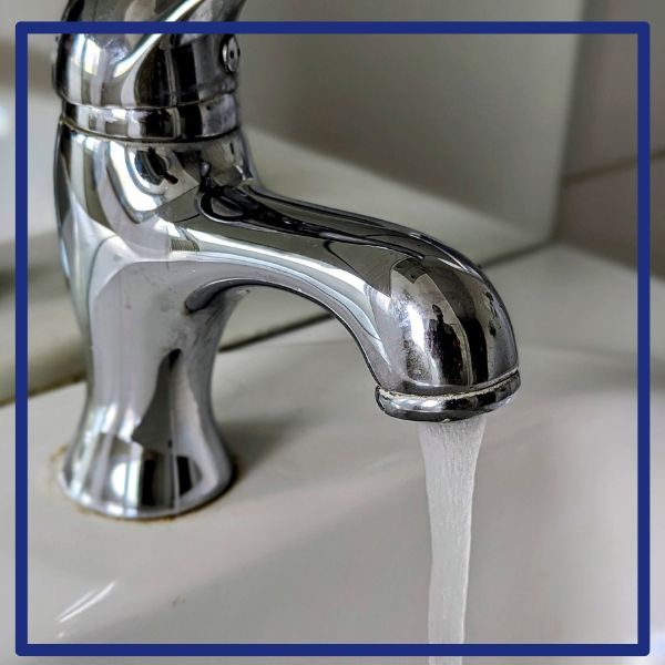 A clean chrome faucet with perfect water flow in an Alpine bathroom after a successful plumbing repair by Plumbing Plus.