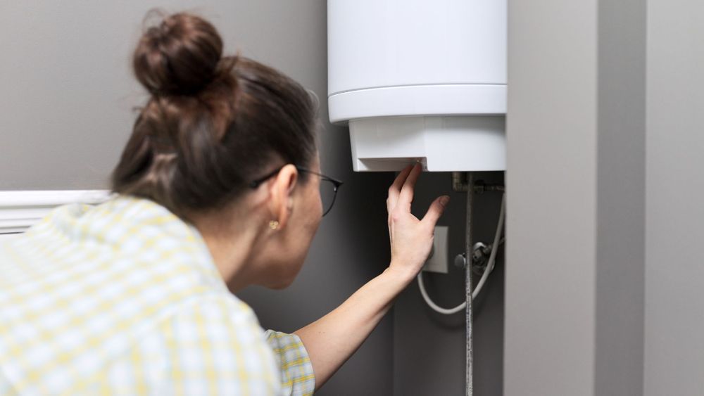 woman adjusting water heater