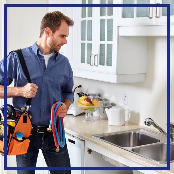 A friendly and professional Plumbing Plus technician arriving in a Poway kitchen with his tool bag, ready to perform a plumbing service. A friendly and professional Plumbing Plus technician arriving in a Poway kitchen with his tool bag, ready to perform a plumbing service.