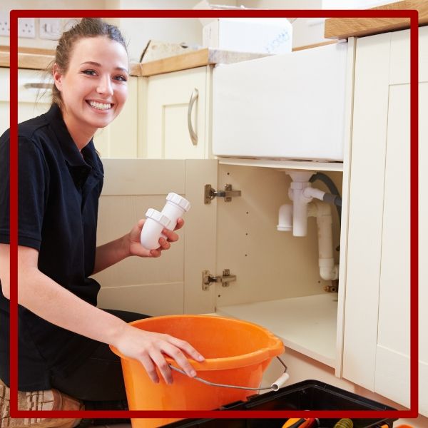 A friendly and skilled female plumber from Plumbing Plus smiling while preparing to repair a kitchen sink drain in Blossom Valley. A friendly and skilled female plumber from Plumbing Plus smiling while preparing to repair a kitchen sink drain in Blossom Valley.