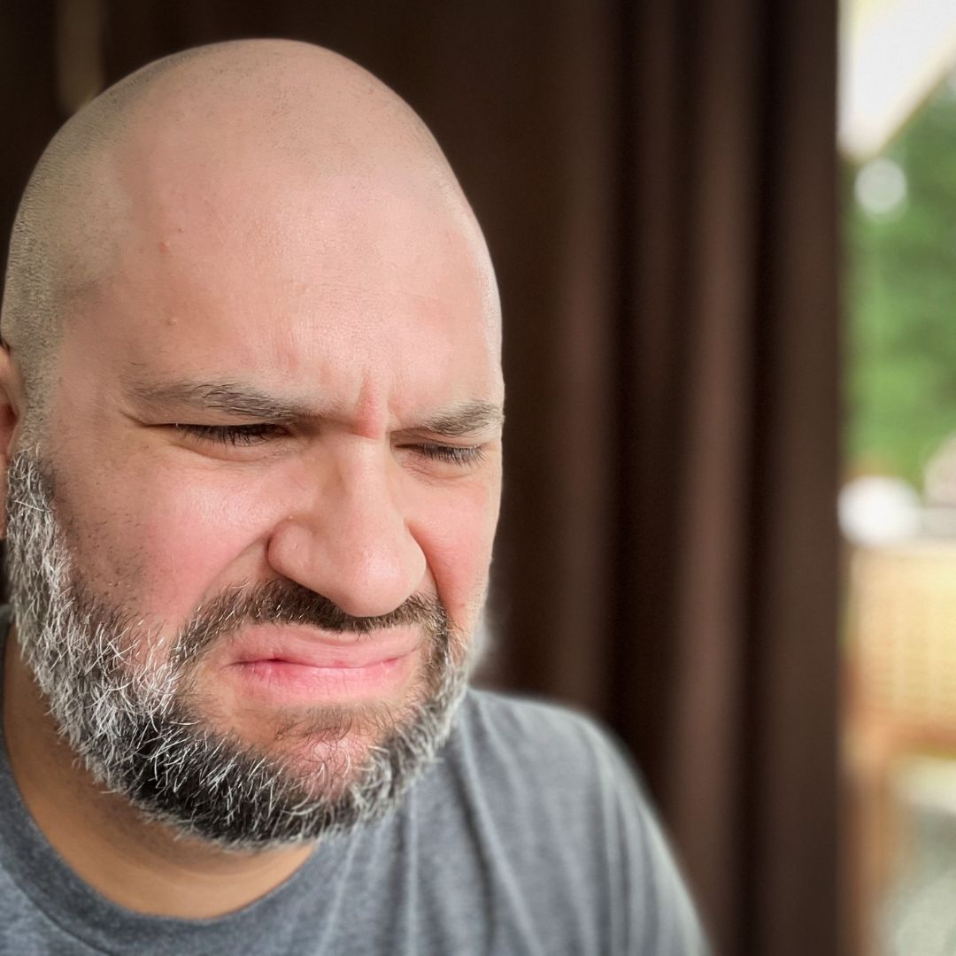 Man smelling something bad