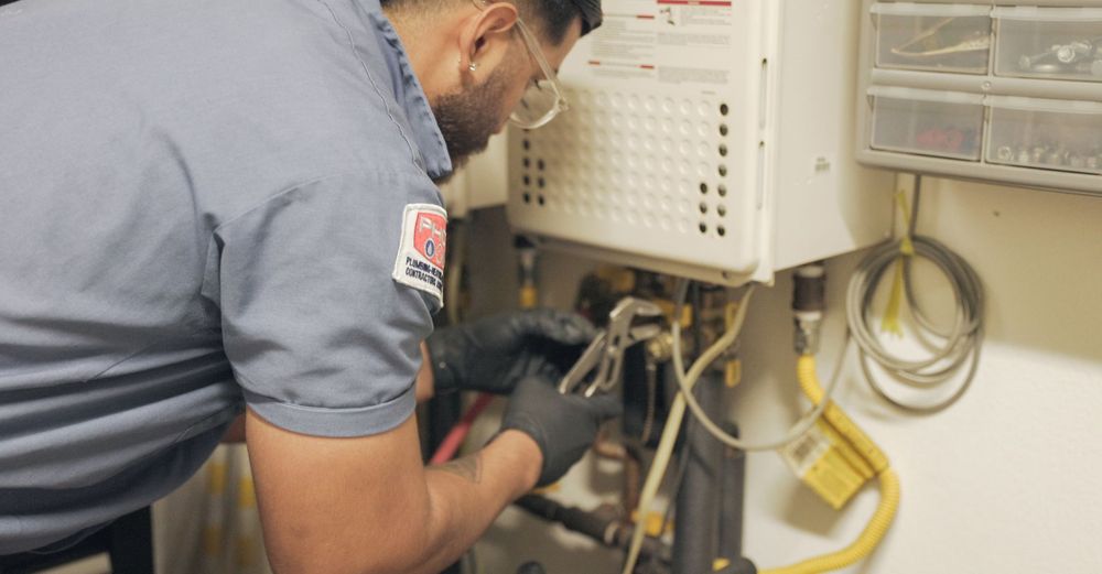 Plumbing Plus working on water heater