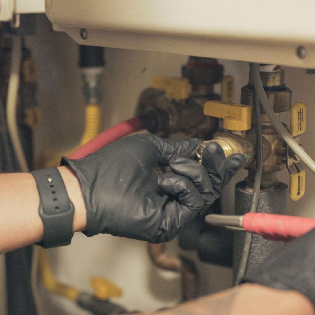 A hand turning a valve