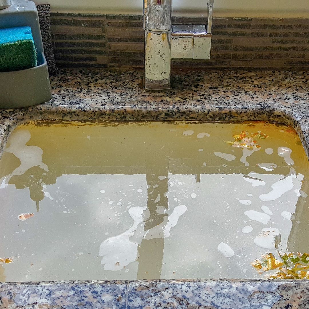 Clogged sink full of backed up water