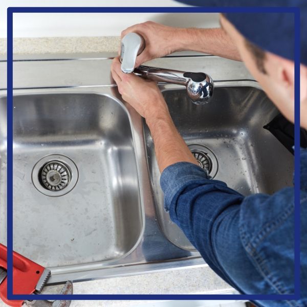 A professional plumber from Plumbing Plus installs or repairs a new faucet on a kitchen sink in a Bay Park home. A professional plumber from Plumbing Plus installs or repairs a new faucet on a kitchen sink in a Bay Park home.