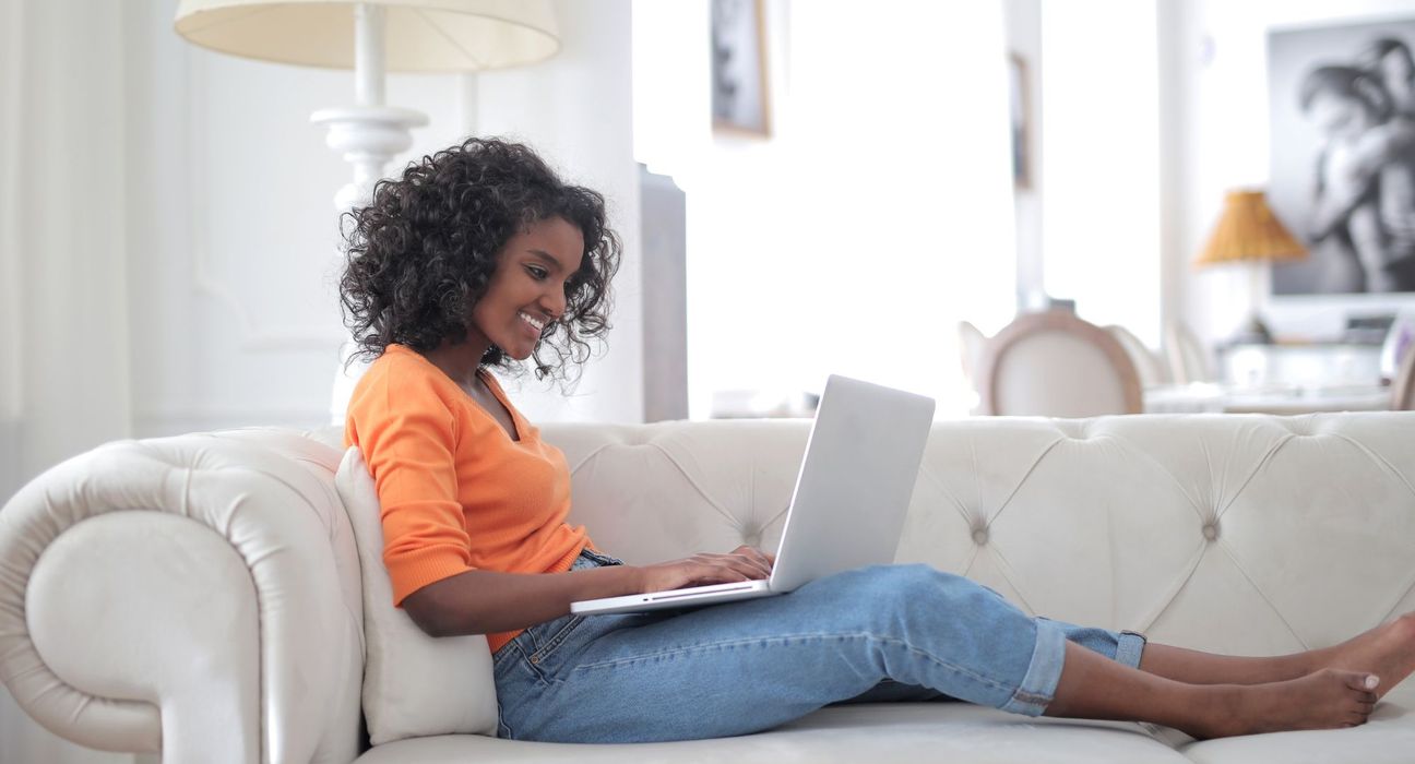 Someone on a laptop comfortable on the couch
