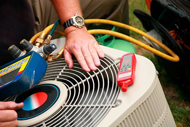 An HVAC technician working on a residential AC unit during a routine repair service in Sacramento. Local HVAC Technician Performing AC Repair in Sacramento