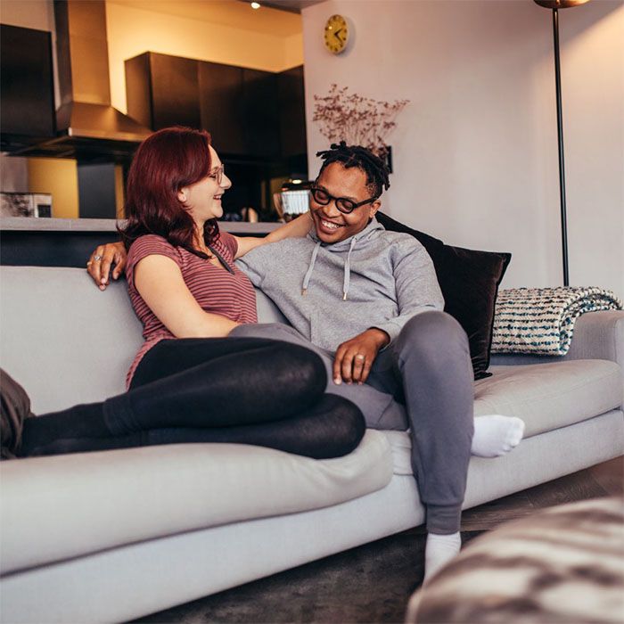 Couple talking on couch in home