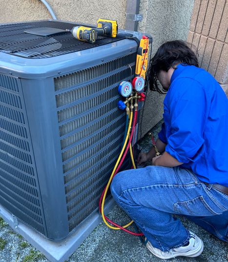 Julian's Heat & AC expert technician performing air conditioning repair in Sacramento, ensuring your home stays cool and comfortable. HVAC technician repairing air conditioning unit outdoors in Sacramento