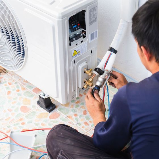 HVAC employee installing new AC unit