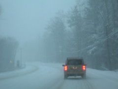 car driving in a snowstorm
