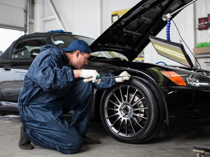 Mechanic checking tires
