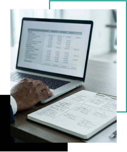 A close-up view of an accountant’s hand resting near a notebook filled with structural diagrams, illustrating the detailed design of a customized Chart of Accounts.