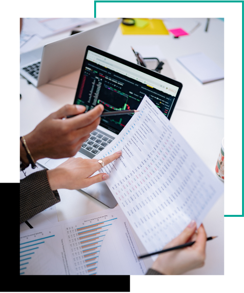 Two people reviewing financial reports. 
