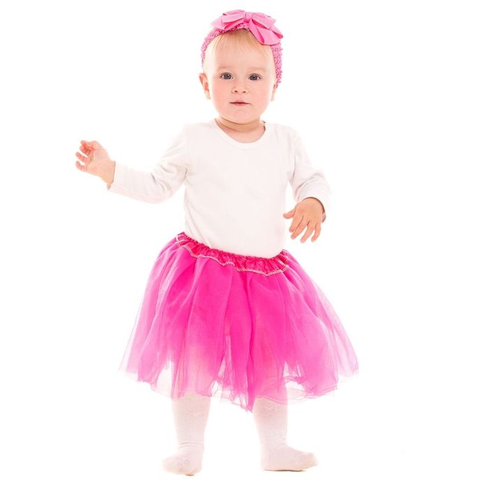 little girl dressed in white shirt with a pink tutu and matching headband