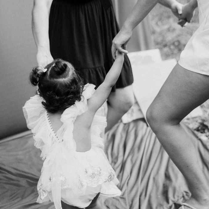 toddler dancing with two adults
