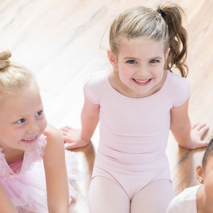 Smiling kids in ballet outfits