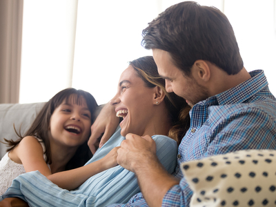 Happy family smiling on the couch.