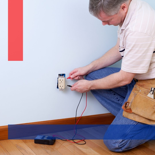Electrician in Sterling, VA repairing a residential wall outlet.