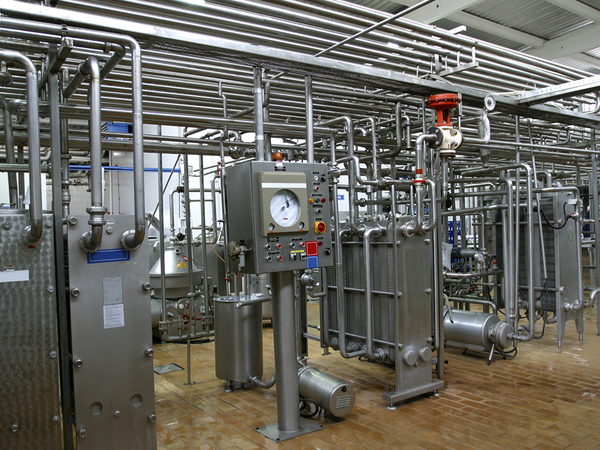  Stainless steel temperature control valves and pipes in modern dairy factory.