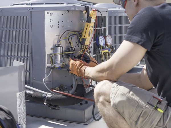 HVAC Technician maintaining AC