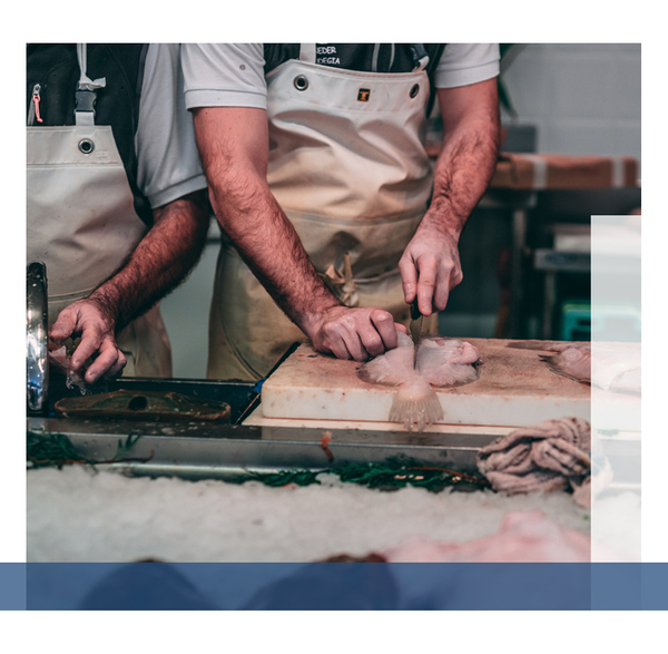 Butcher cutting a piece of meat.