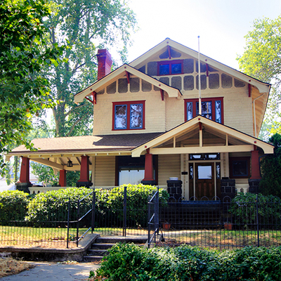 Beautiful home with ran trim and red pillars.