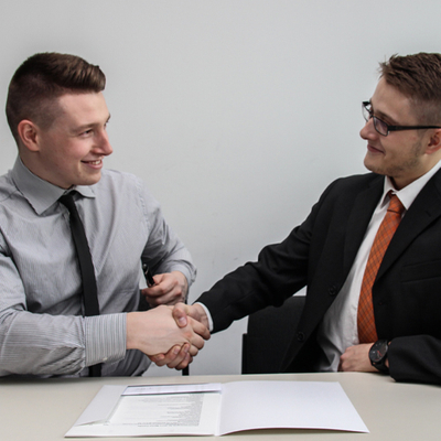 Two men shaking hands after a deal.