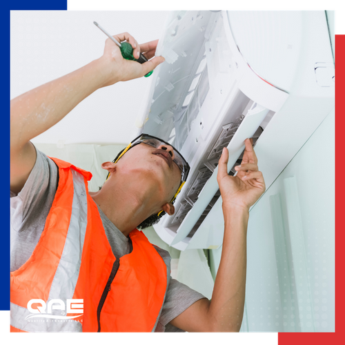AC repair tech working inside a home.