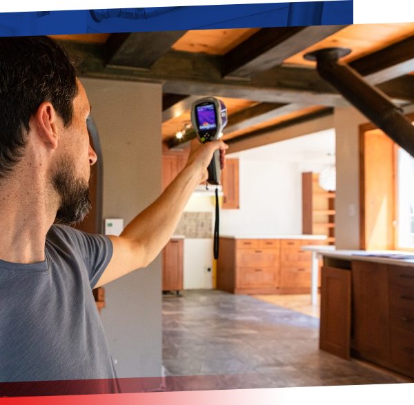 Image of man measuring thermal temperatures in house