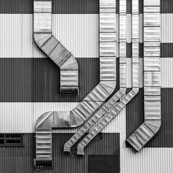 array of HVAC vents on exterior of warehouse/industrial building