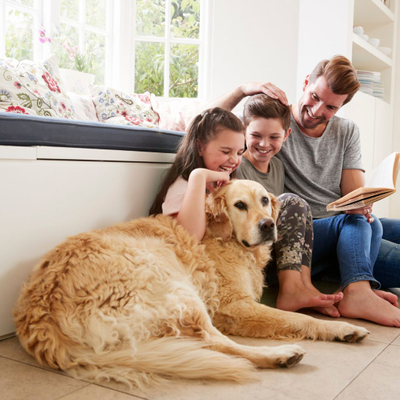 Dad and kids sitting with a dog