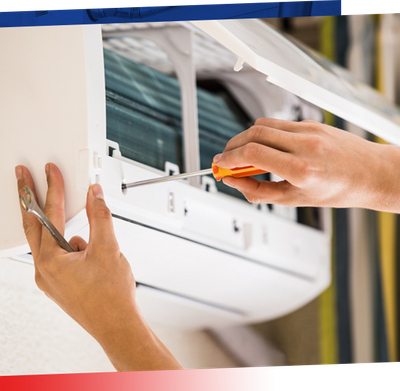 Image of hands working on an AC window unit