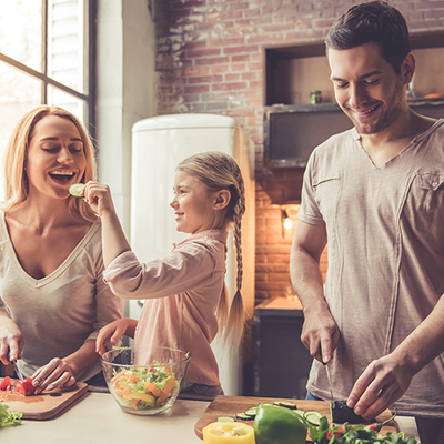 Happy family cooking dinner in the kitchen.