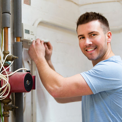 Man smiling while making repairs
