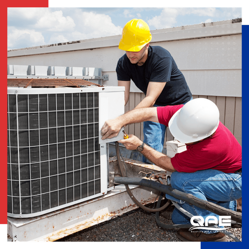 AC repair technicians working on an outdoor condenser 