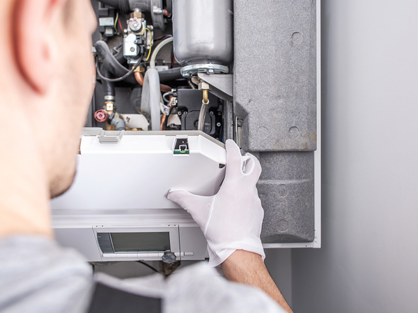  Close Up Of Service Worker Fixing Central Heating Furnace System.