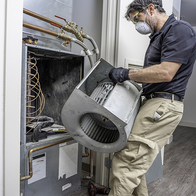 HVAC technician repairing a unit.